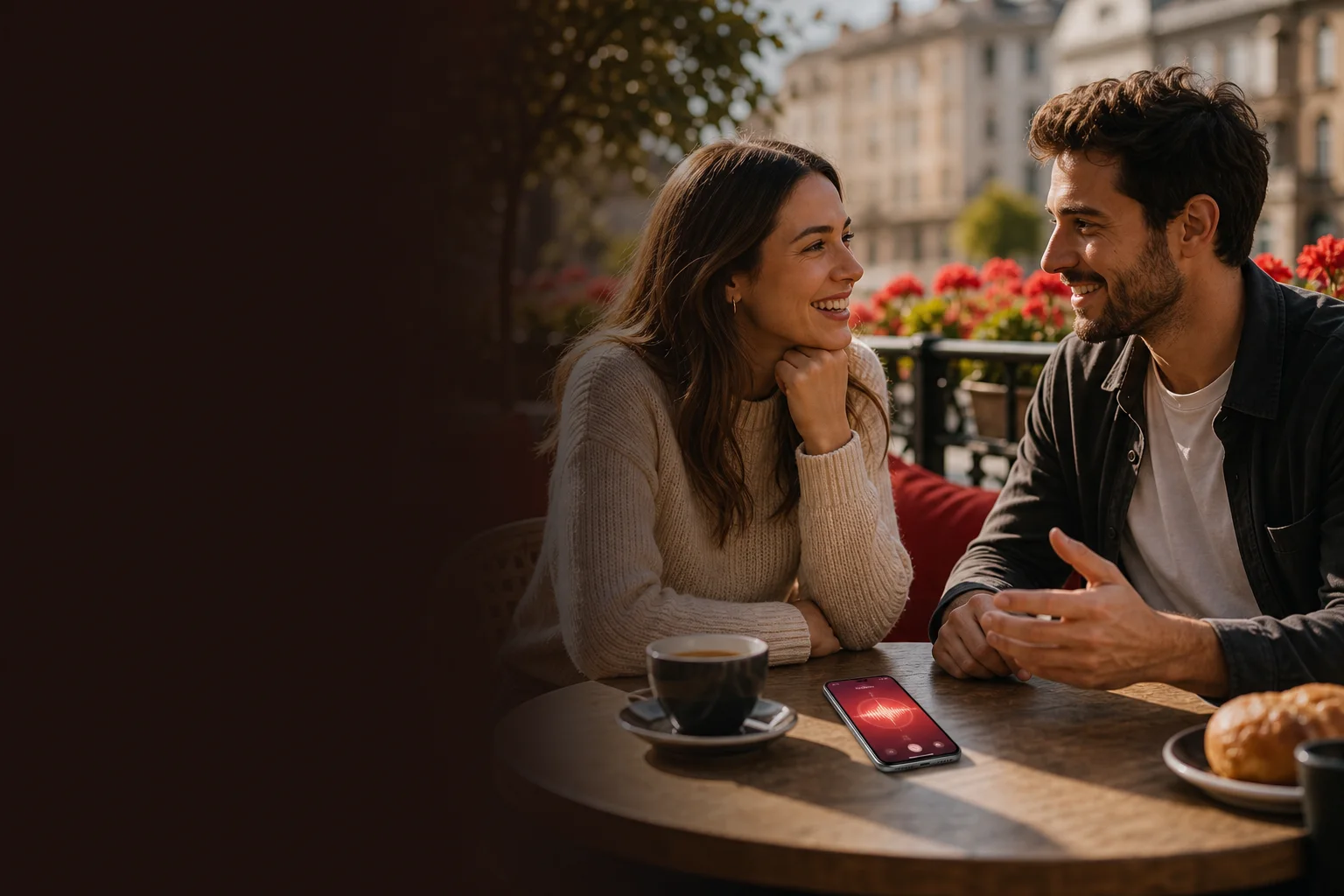 Two adults talking at a cafe with the Ruvy Talk app open on a phone